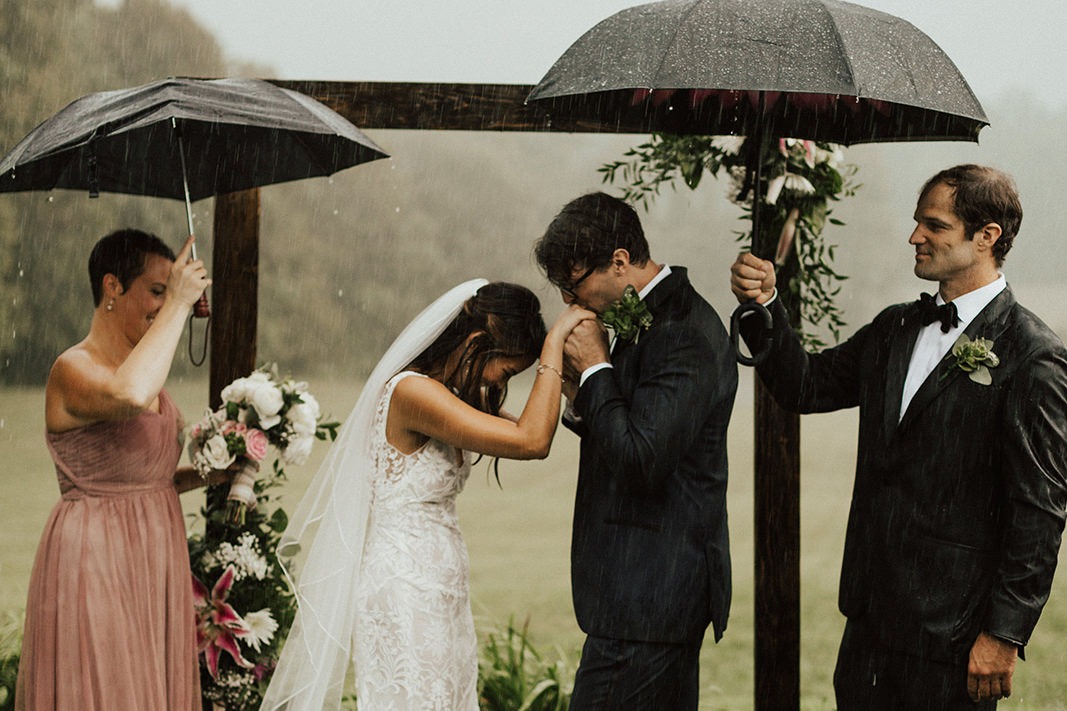 Bride and groom caught in the rain for their wedding ceremony
