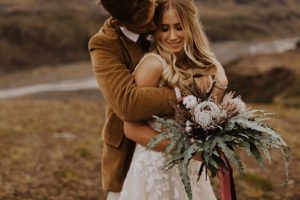 groom hugs wife from behind