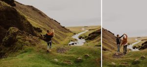 man carries and twirls fiance at waterfall in iceland