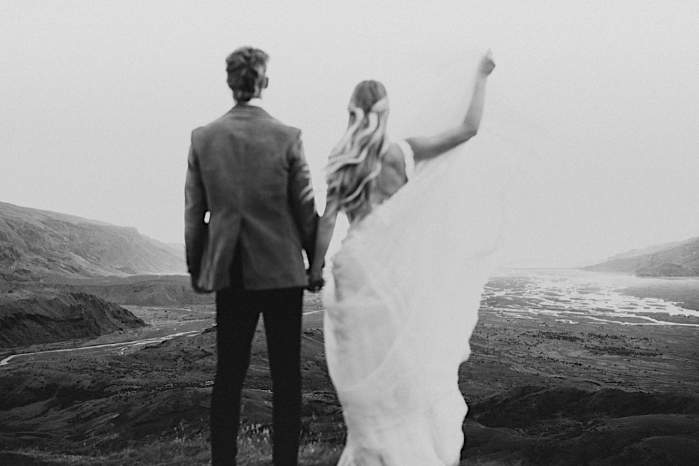 black and white portrait of couple looking at mountains