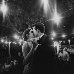 Couples kisses at backyard wedding