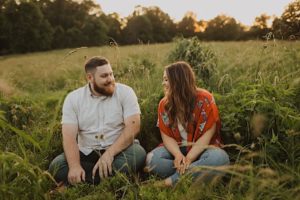 man and woman sit criss cross applesauce