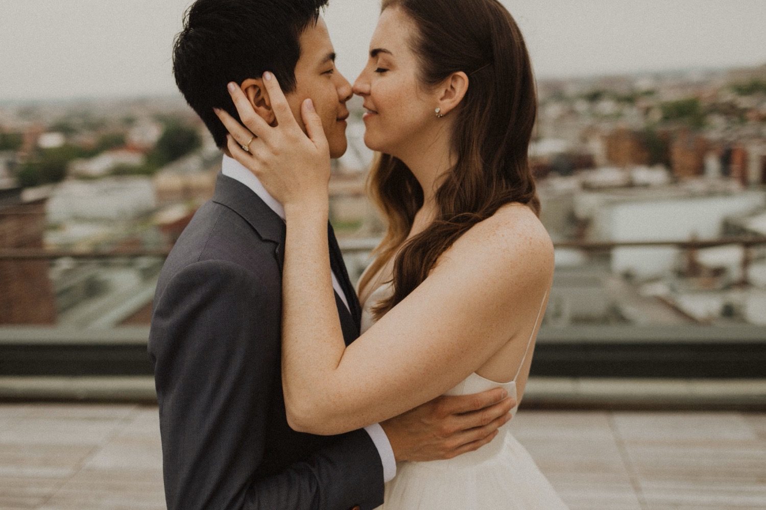 Bride and groom eskimo kiss at the line dc hotel rooftop