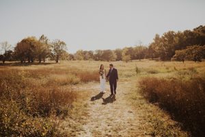 groom leads new wife while walking