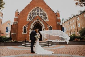Bride and groom kiss outside of chapel