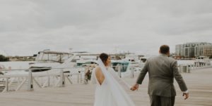 bride and groom walk through navy yard
