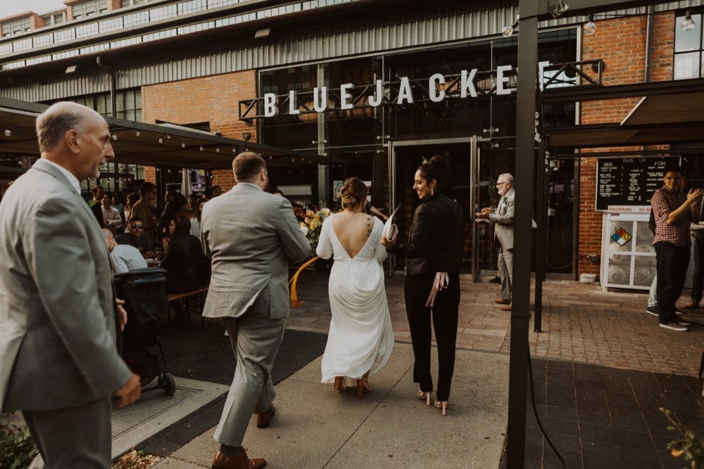 bride and groom walk into blue jacket brewery in navy yard