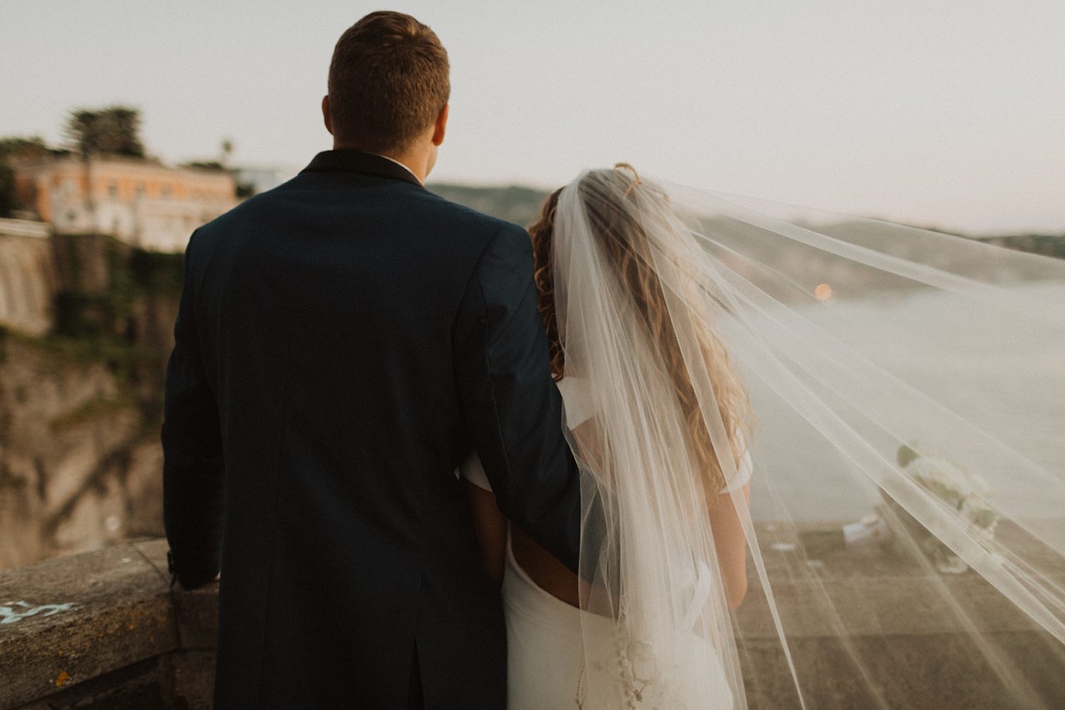 Bride's cathedral veil flows in wind
