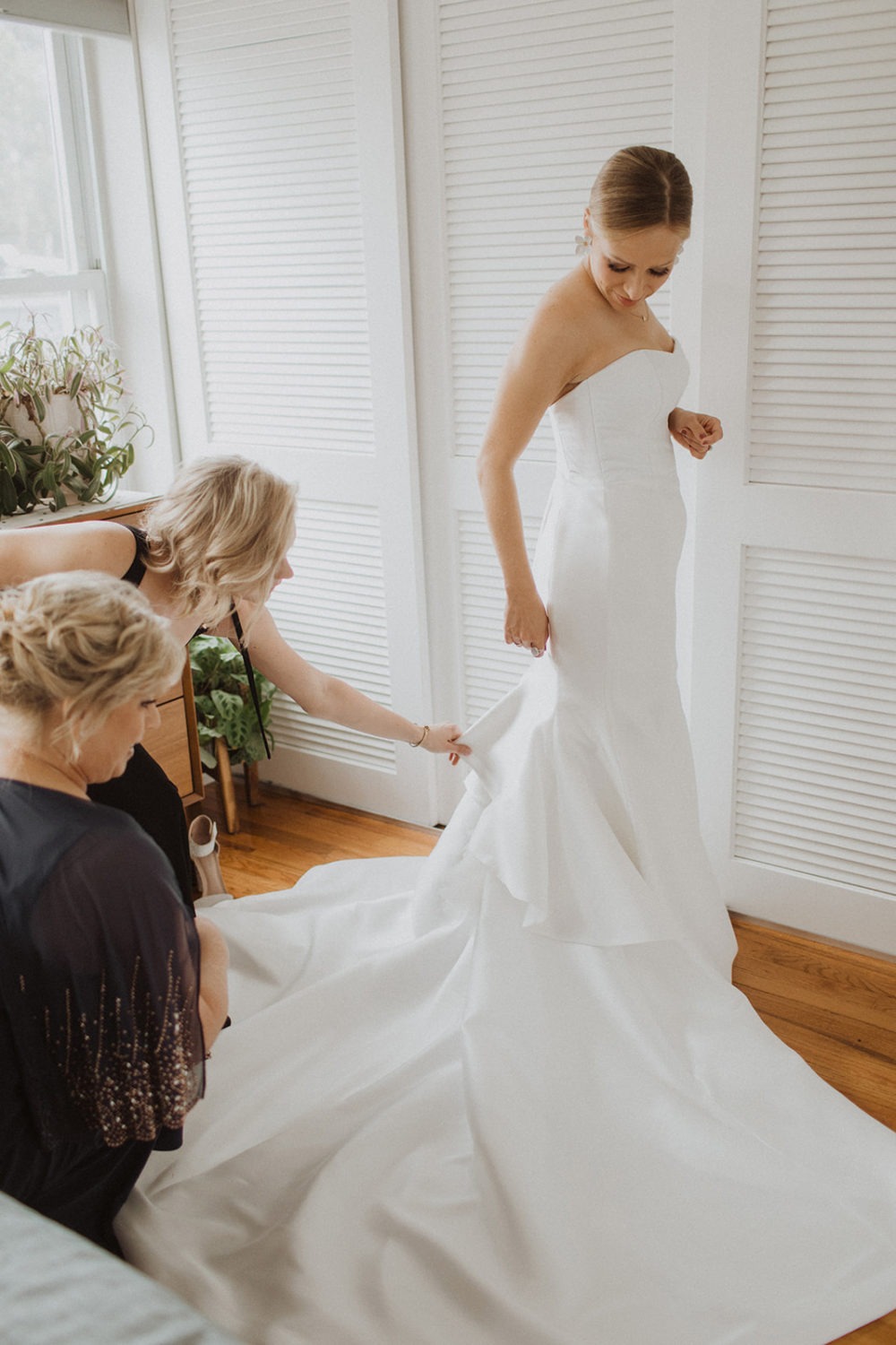 Bride puts on wedding dress for her intimate wedding