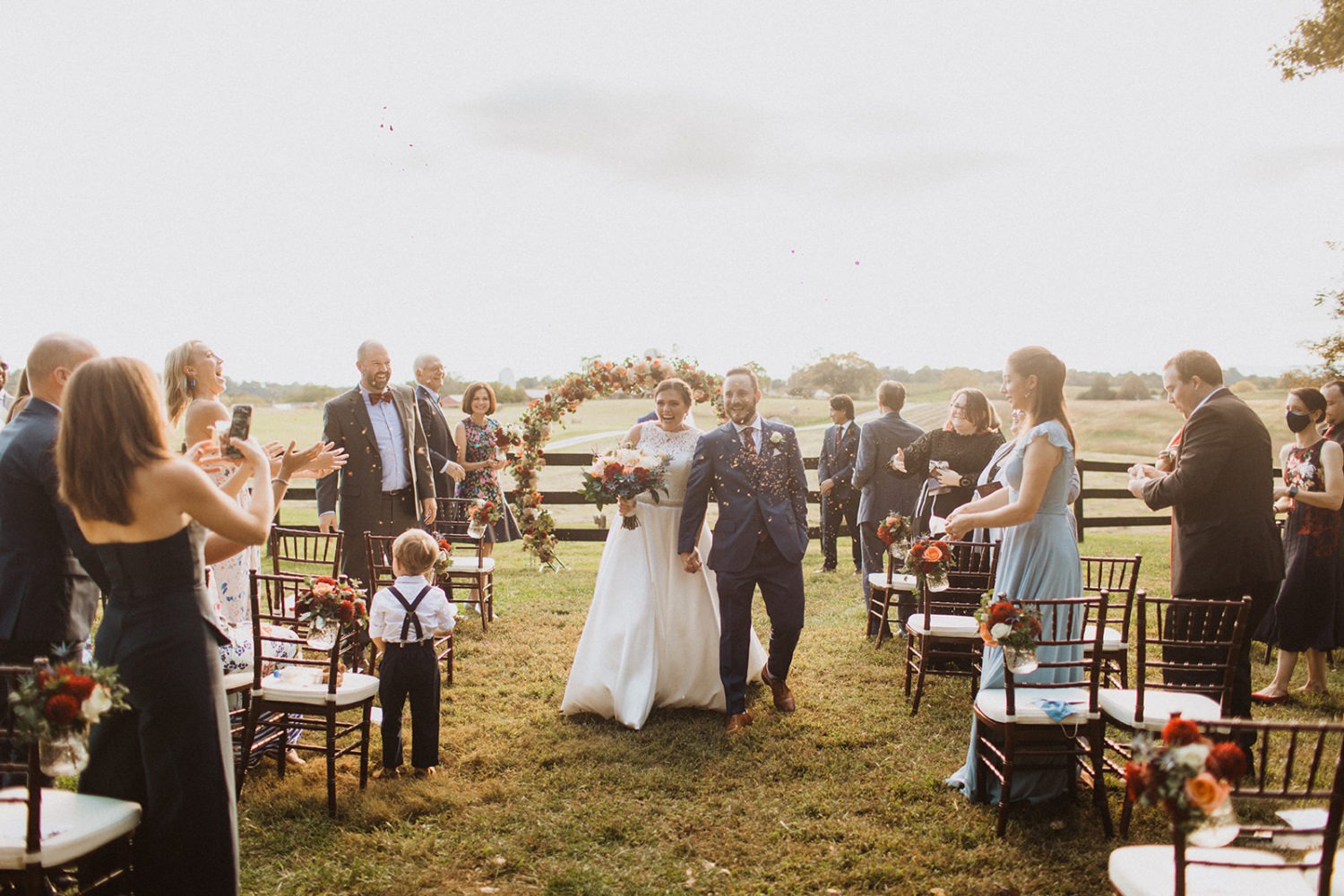 Couple holds hands exiting ceremony at Goodstone Inn virginia wedding venue