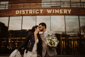 Wedding couple kisses outside of district winery in washington, dc