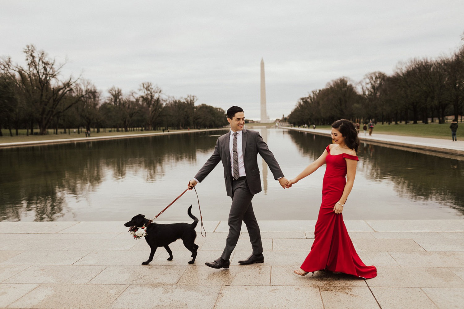 Couple walks dog at National Mall
