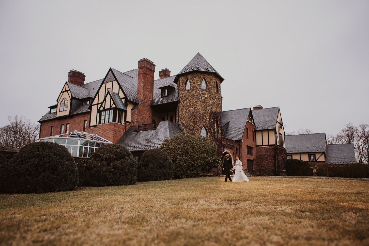 Couple walks alongs grounds of Dover Hall wedding venue