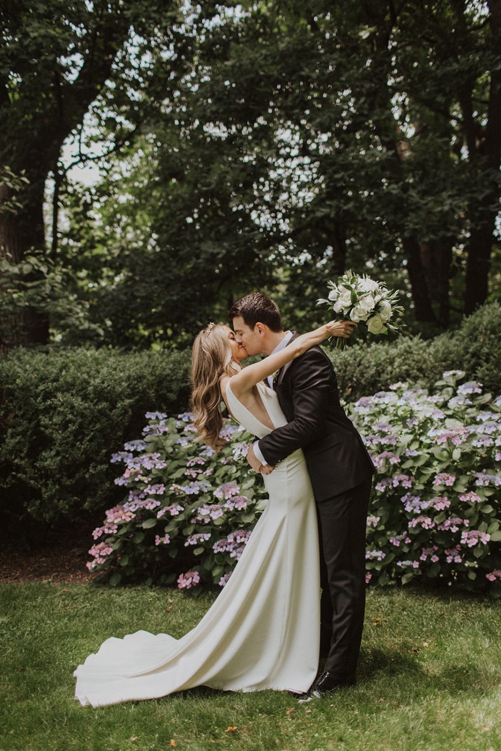 Couple kisses in garden at Georgetown Tudor Place wedding