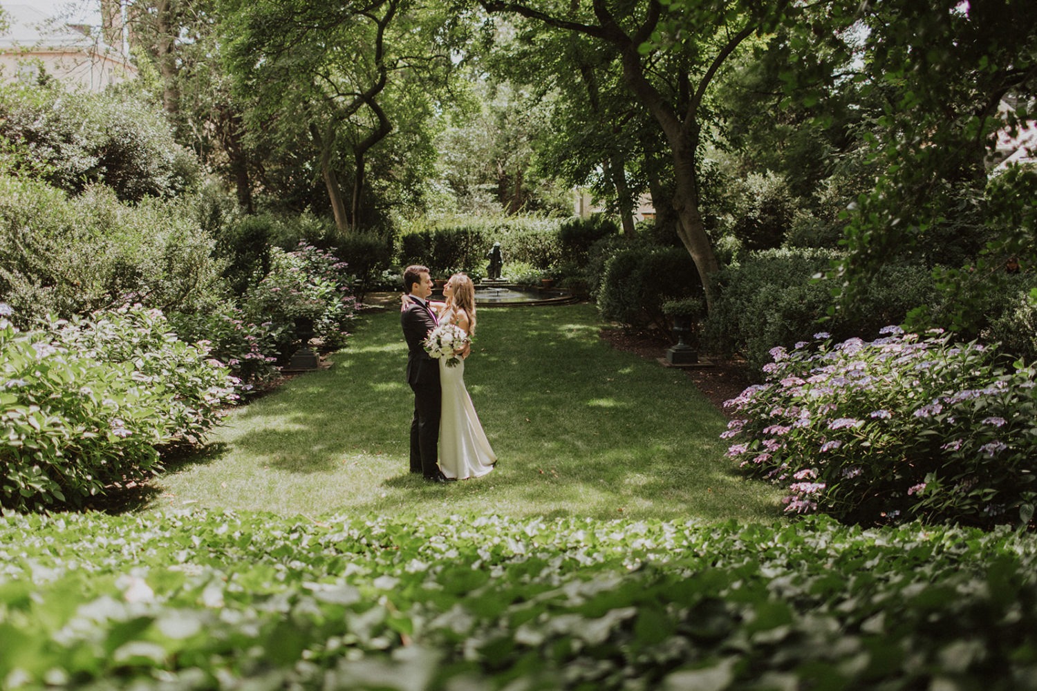 Couple embraces in garden at Georgetown Tudor Place wedding