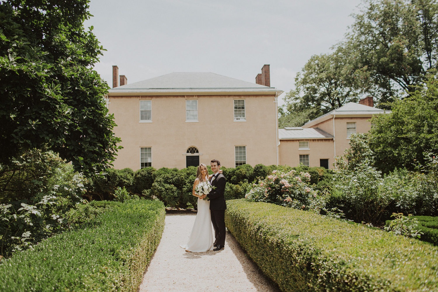 Couple embraces in garden at Georgetown Tudor Place wedding
