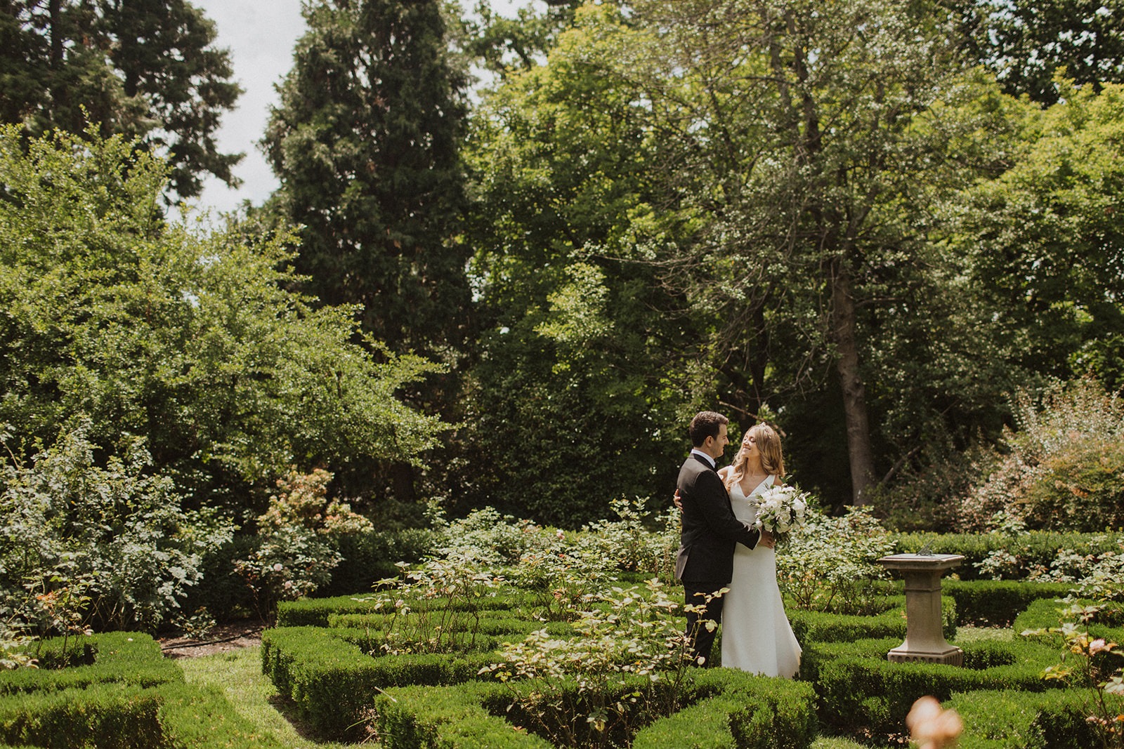 Couple embraces at European Style intimate wedding in garden