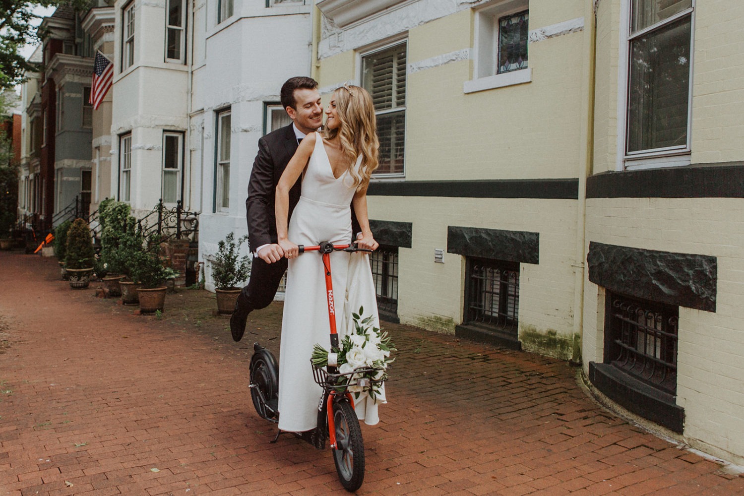 Couple rides scooter on Georgetown streets at Tudor Place wedding