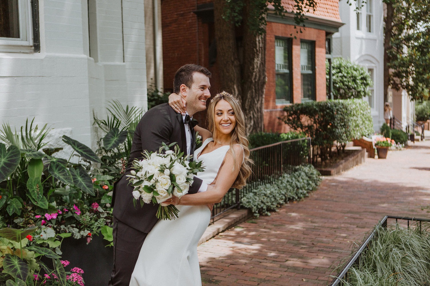 Couple embraces on Georgetown streets at Tudor Place wedding