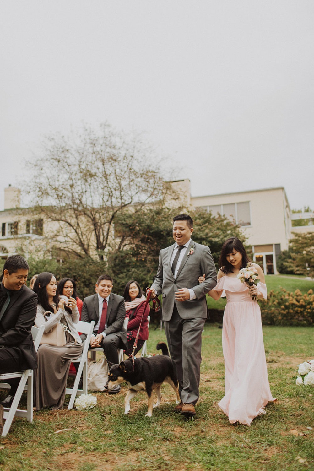 Groomsmen walks dog down the aisle at Virginia outdoor wedding.