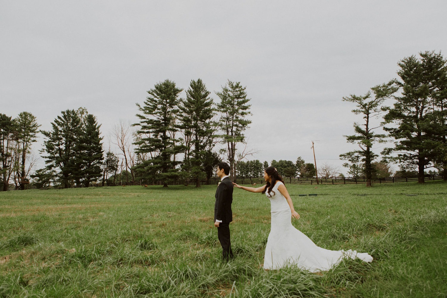 Bride and groom have first look in field at Virginia outdoor wedding.