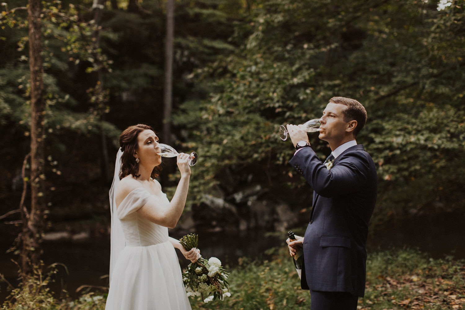 Couple drinks champagne at Rock Creek Park elopement