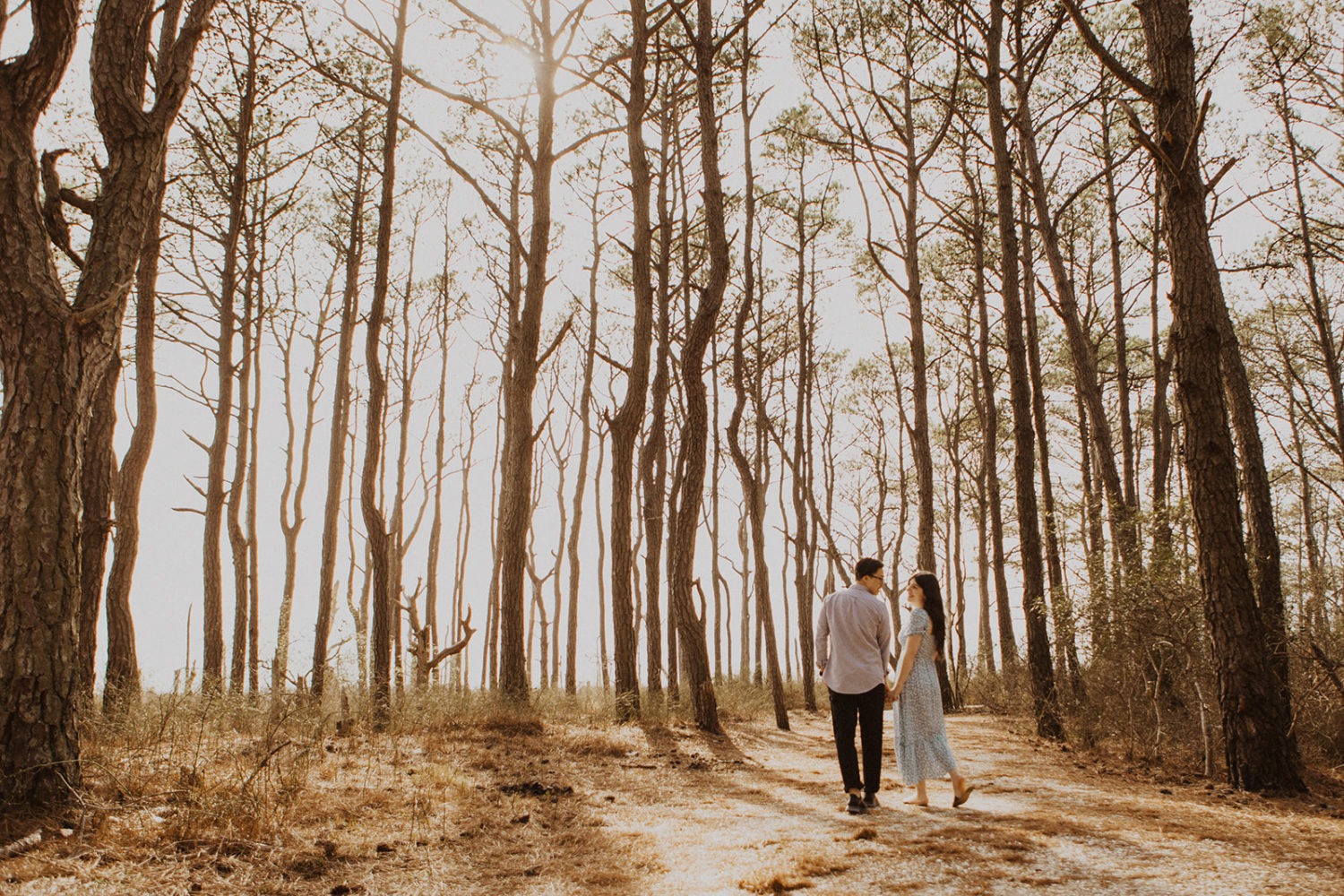 Couple walks holding hands at Assateague Island elopement