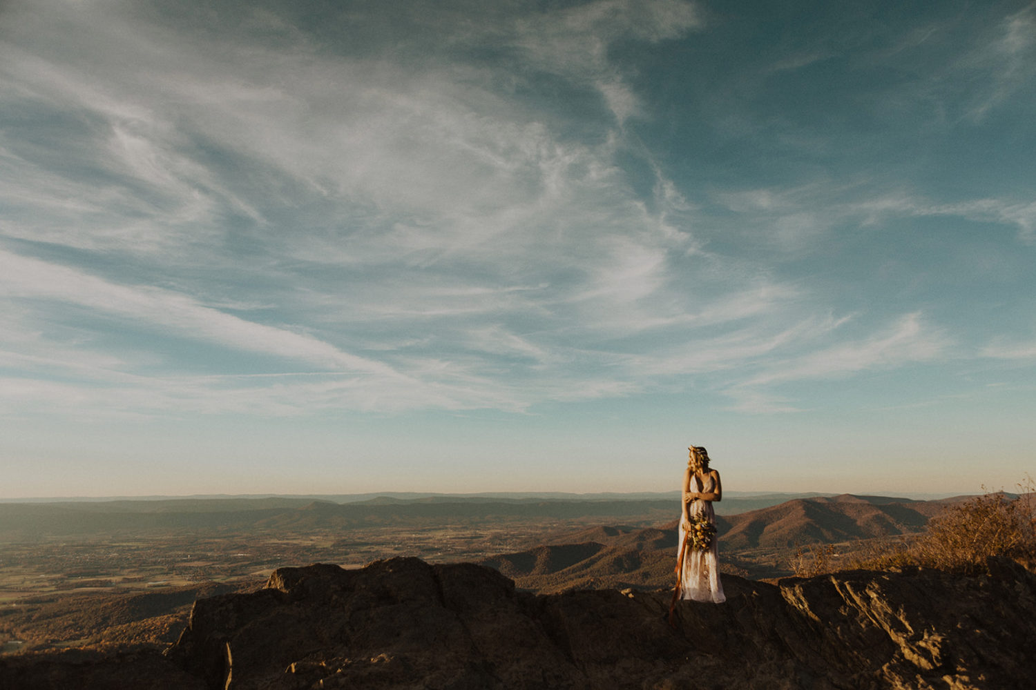 Bride stands on hill at Shenandoah National Park