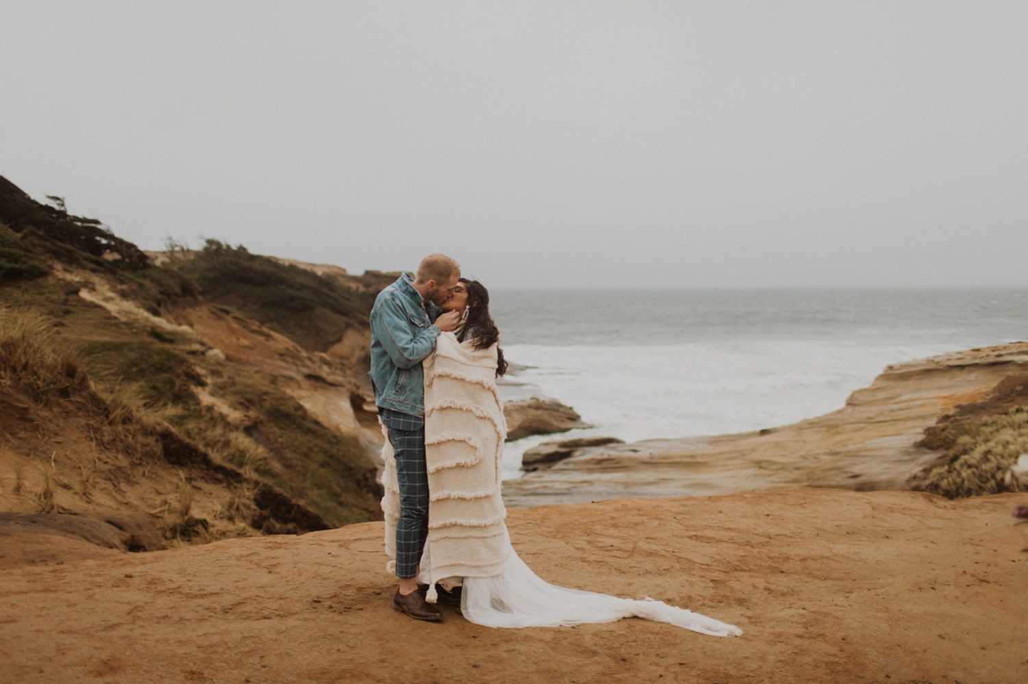 Couple kisses at Oregon coast elopement