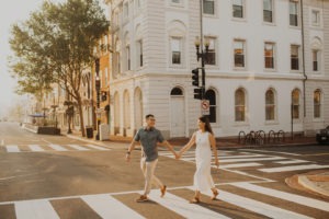 Couple walks holding hands at Georgetown engagement session