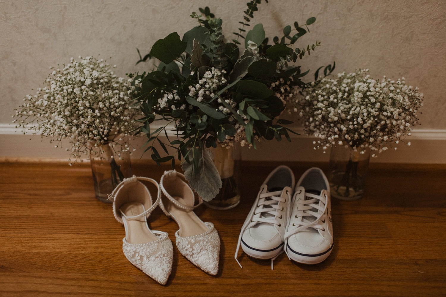 Bridal shoes with flowers set on floor