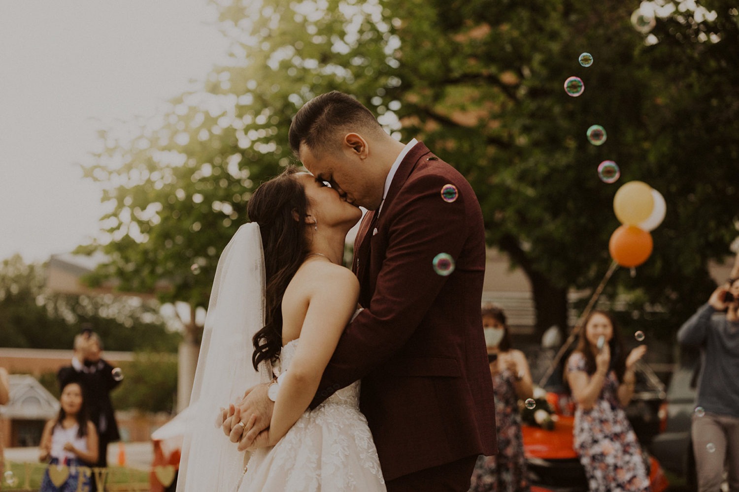Couple kisses at COVID-restricted wedding