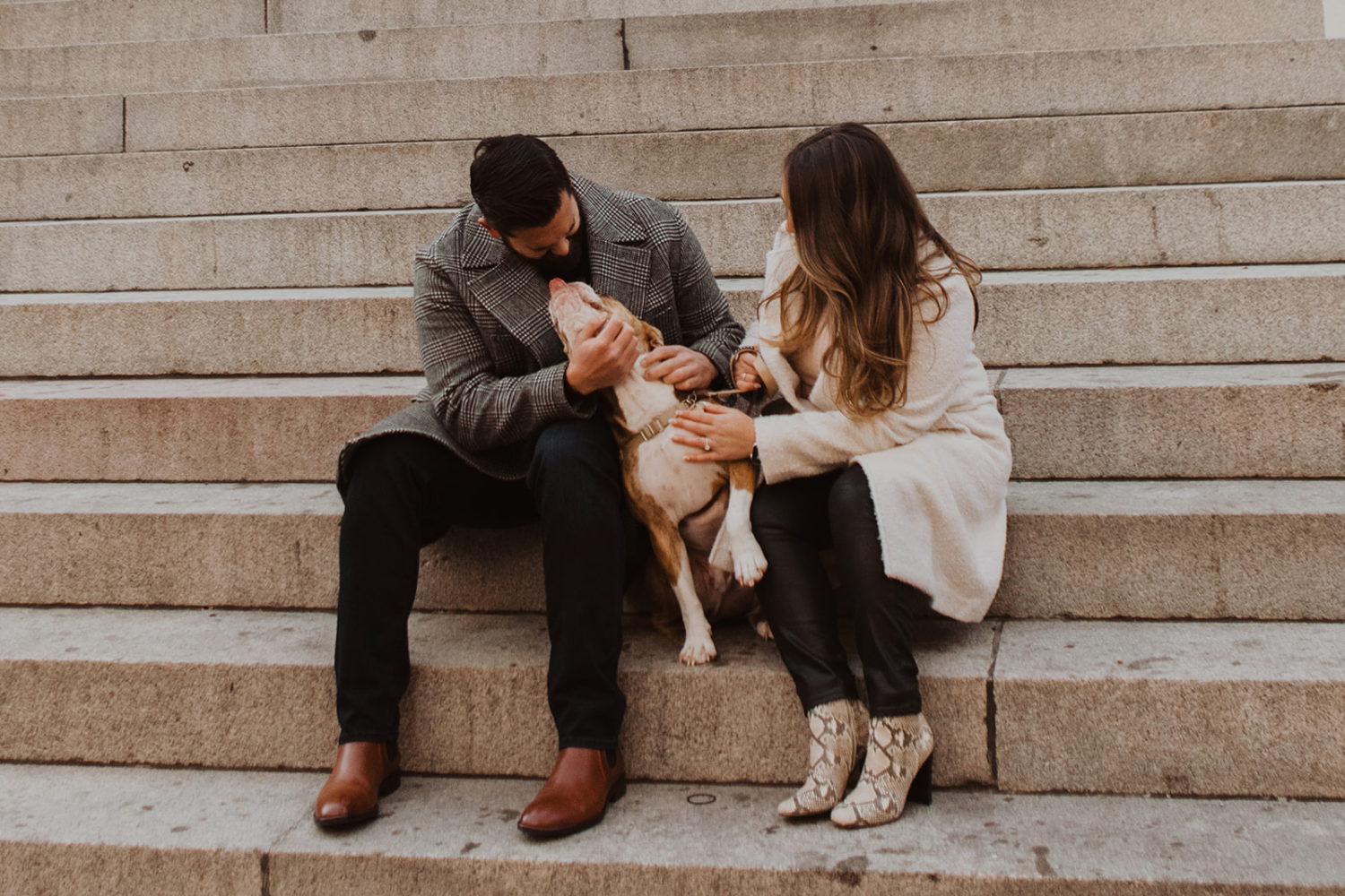 Couple embraces with dog at Washington DC winter engagement photo session