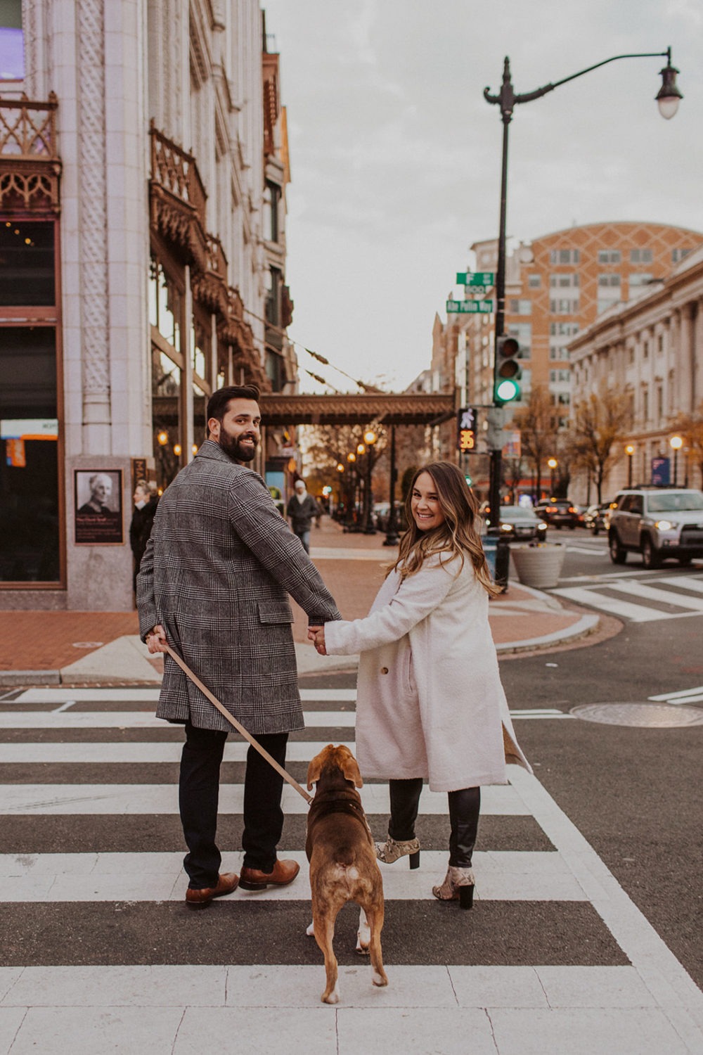 Couple walks with dog at Washington DC winter engagement photo session