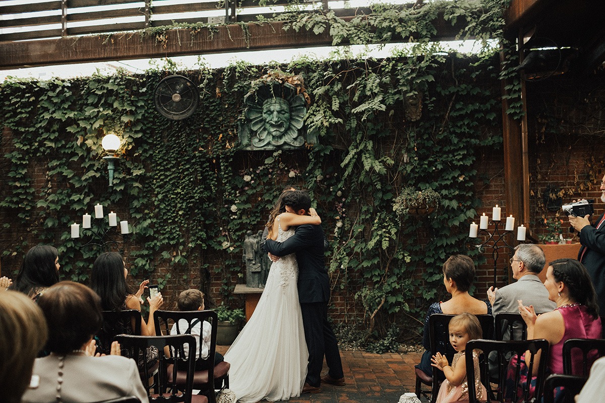 Couple embraces during ceremony at Tabard Inn DC garden wedding venue