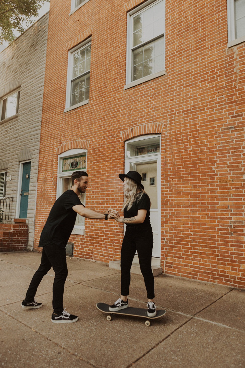 Couple rides skateboard together at Baltimore engagement session