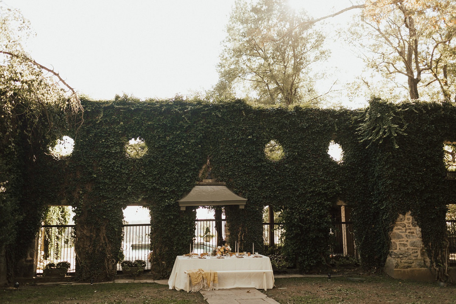 Ivy-covered wall with table setting at Goodstone Inn Virginia garden wedding