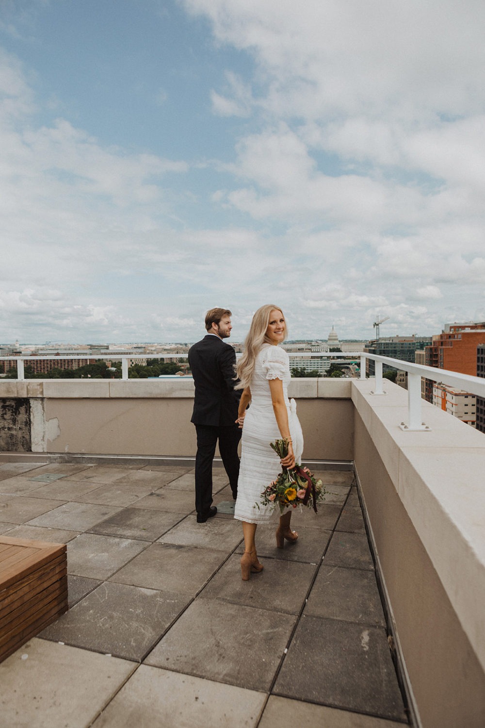 Couple holds hands at Washington DC rooftop elopement