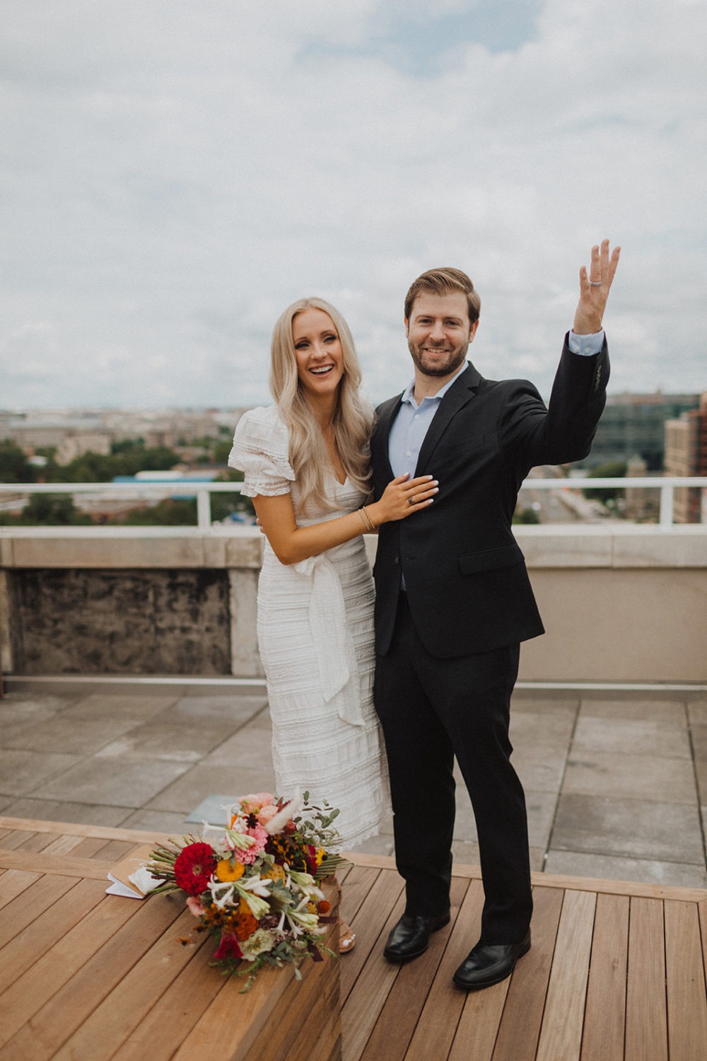 Couple smiles at Washington DC rooftop elopement