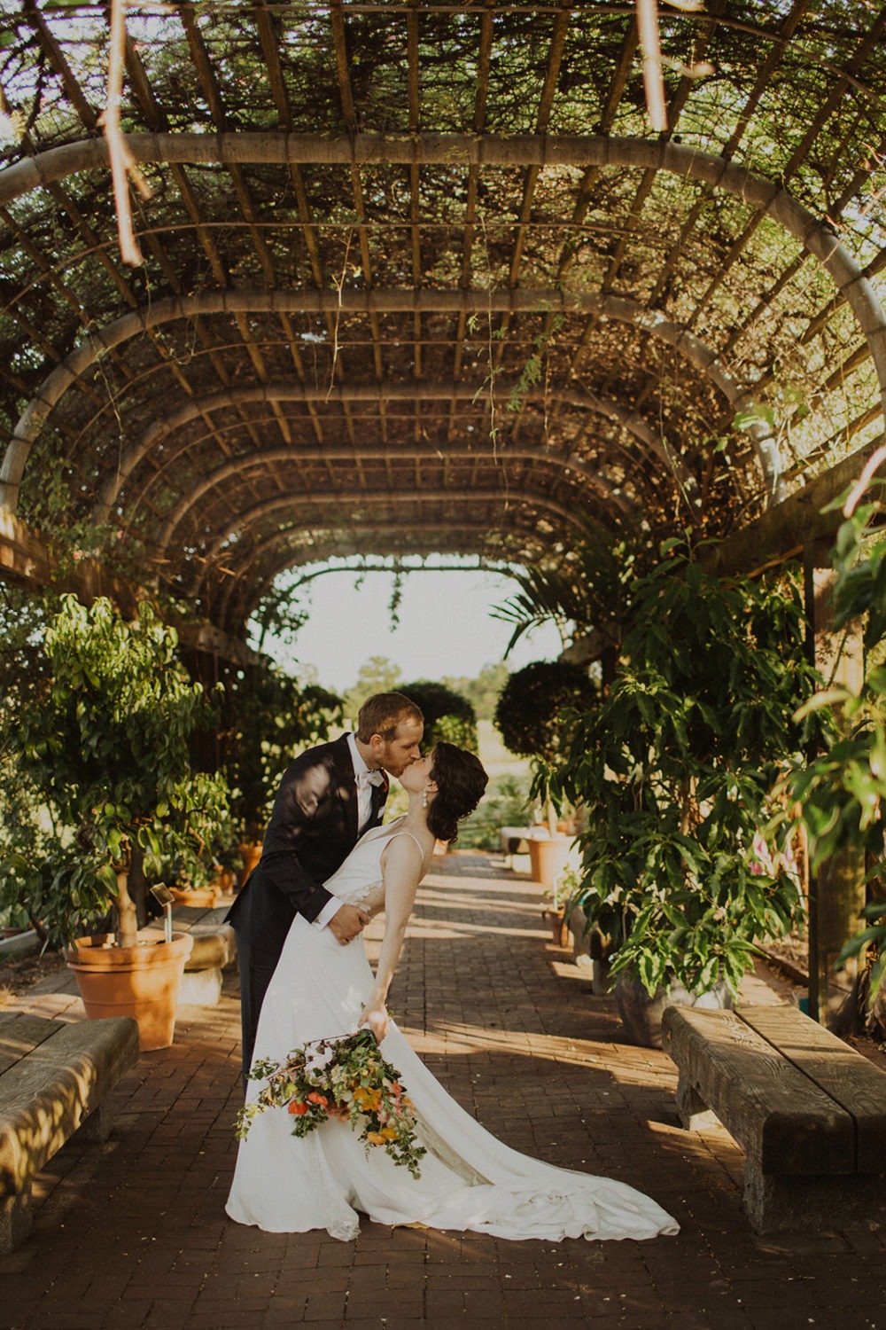 Couple kisses at National Arboretum garden wedding