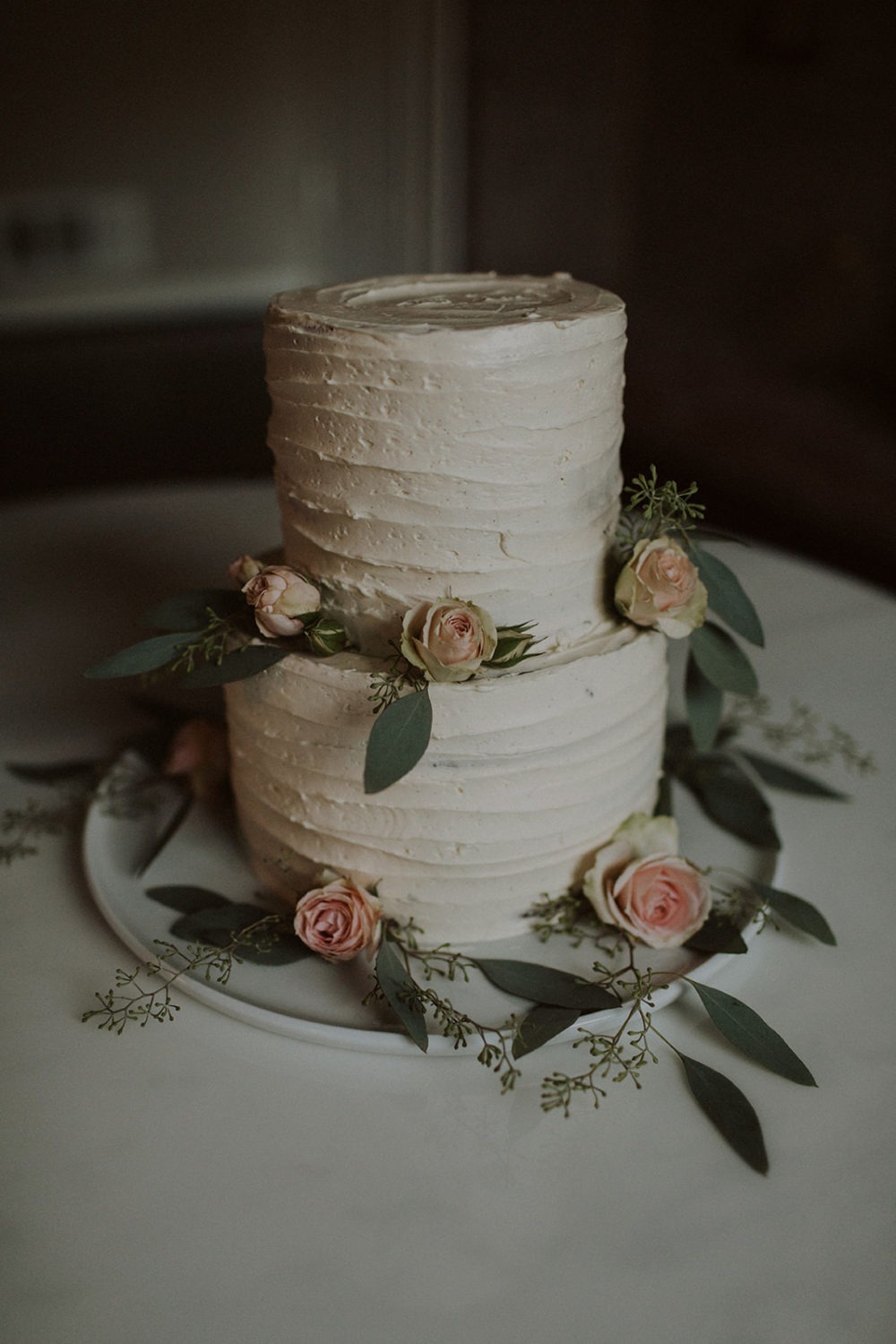 White wedding cake decorated by flowers