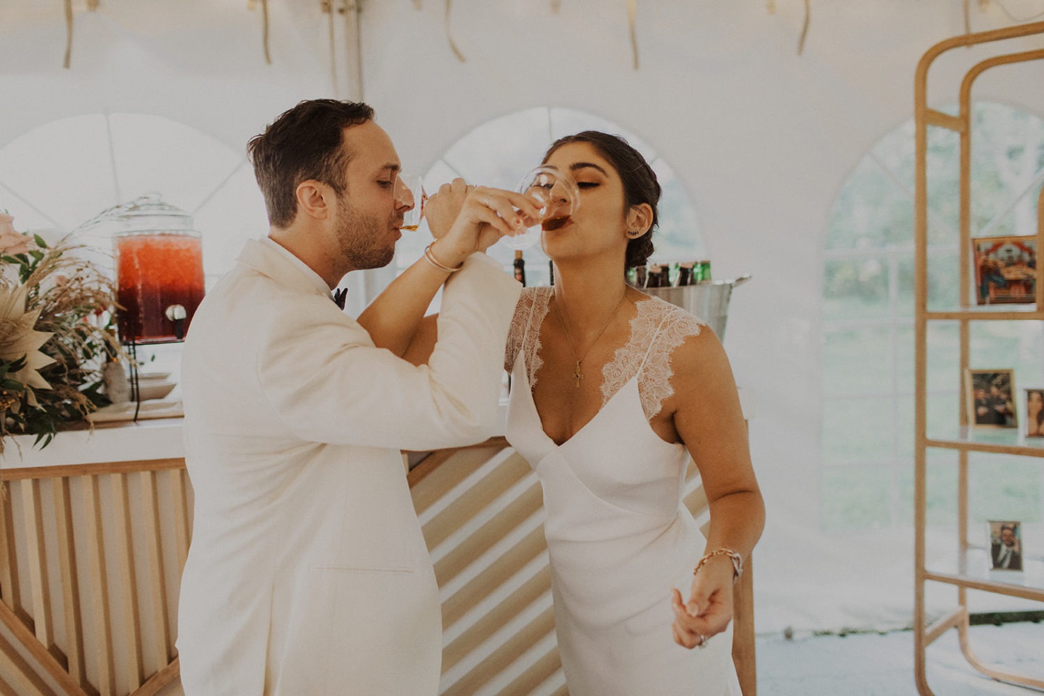 Couple drinks wine in reception tent