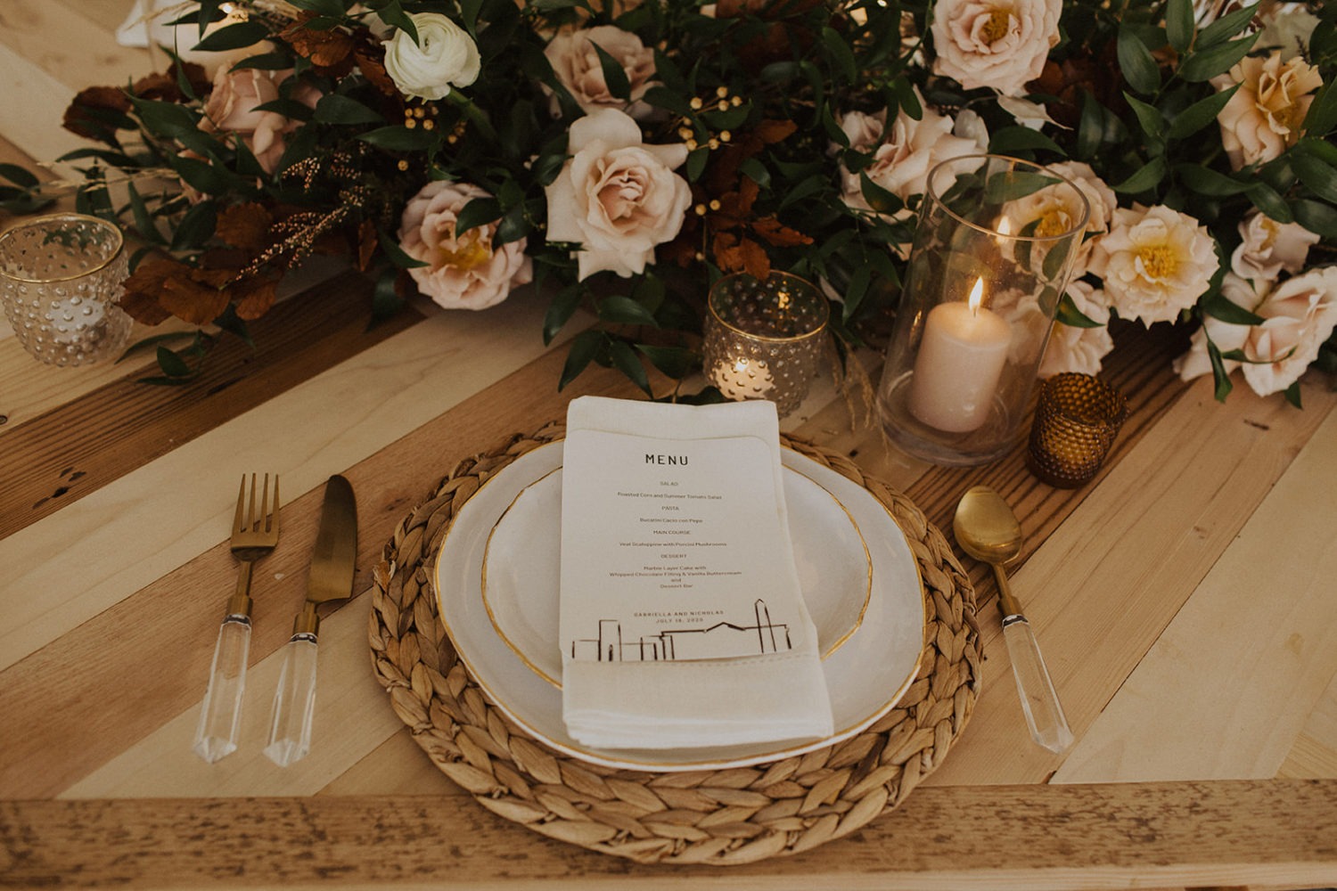 Flowers and candles with table setting at reception