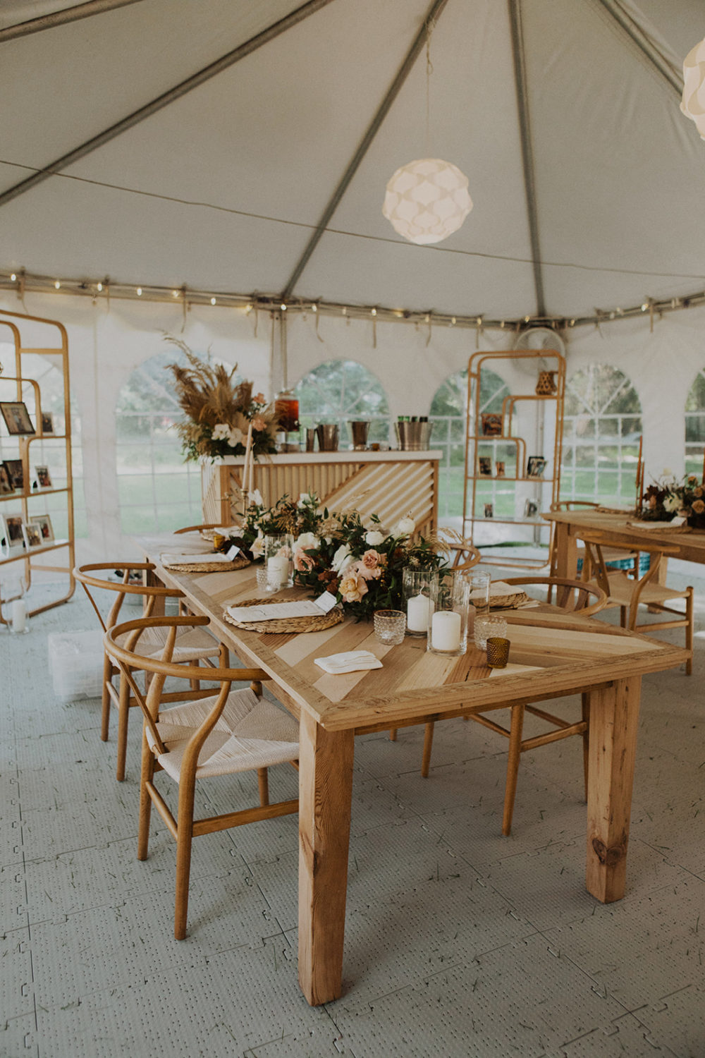 Decorated tables fill the tented wedding reception space