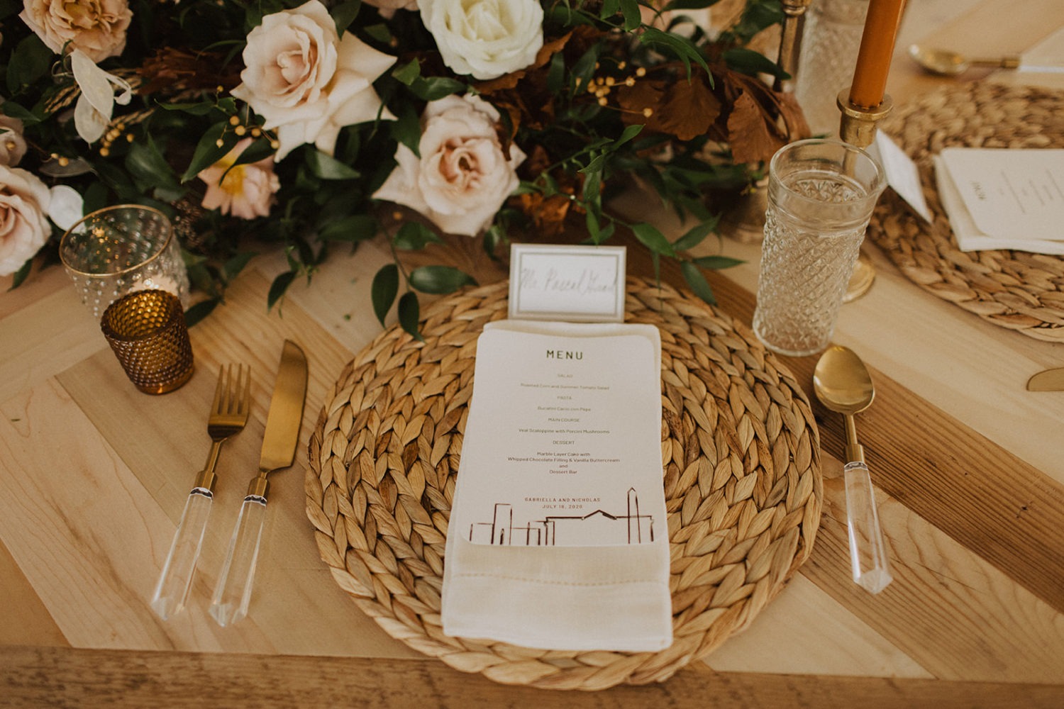 Menu and gold cutlery decorate tables at backyard wedding reception