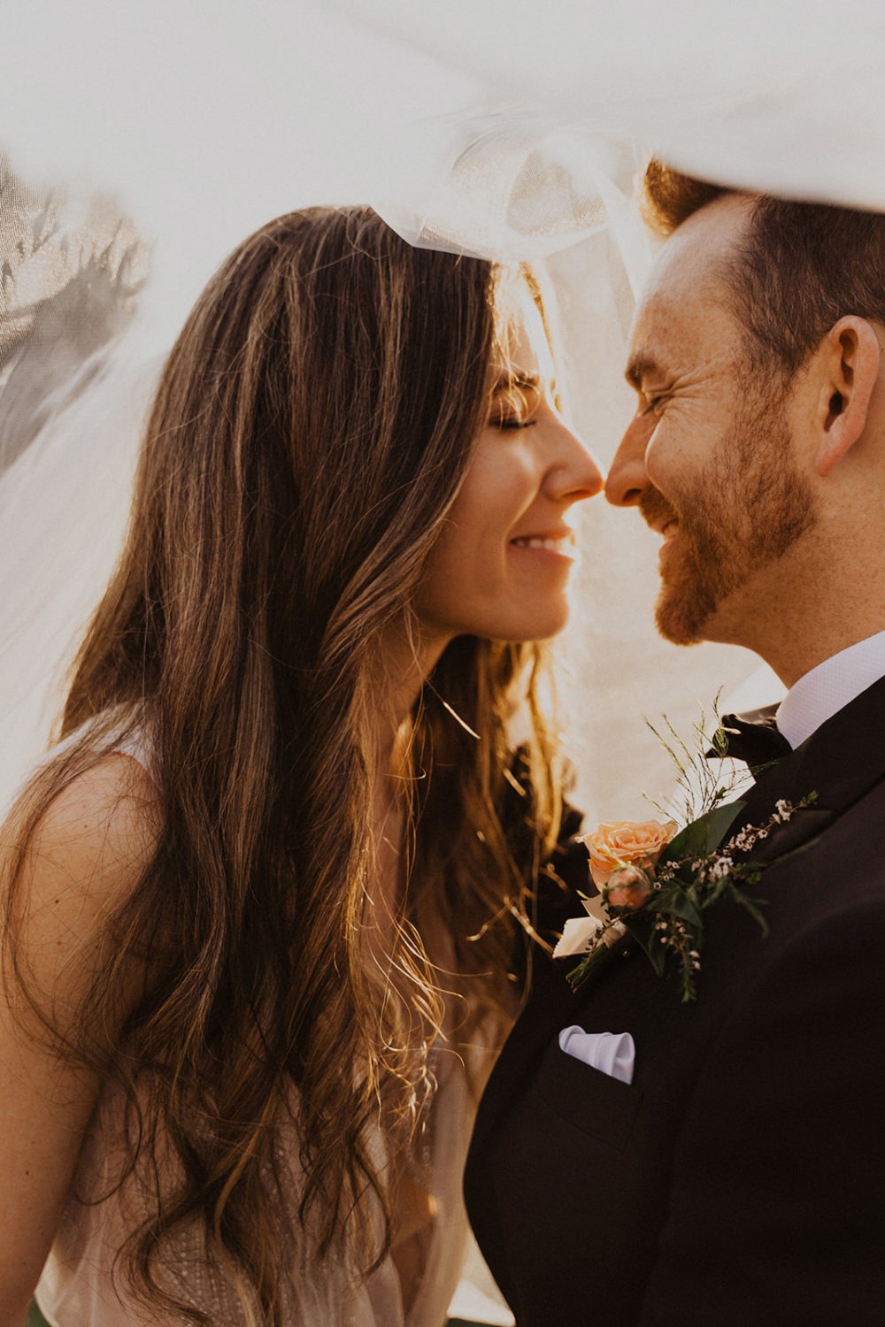 Couple kisses under veil at Virginia wedding venue