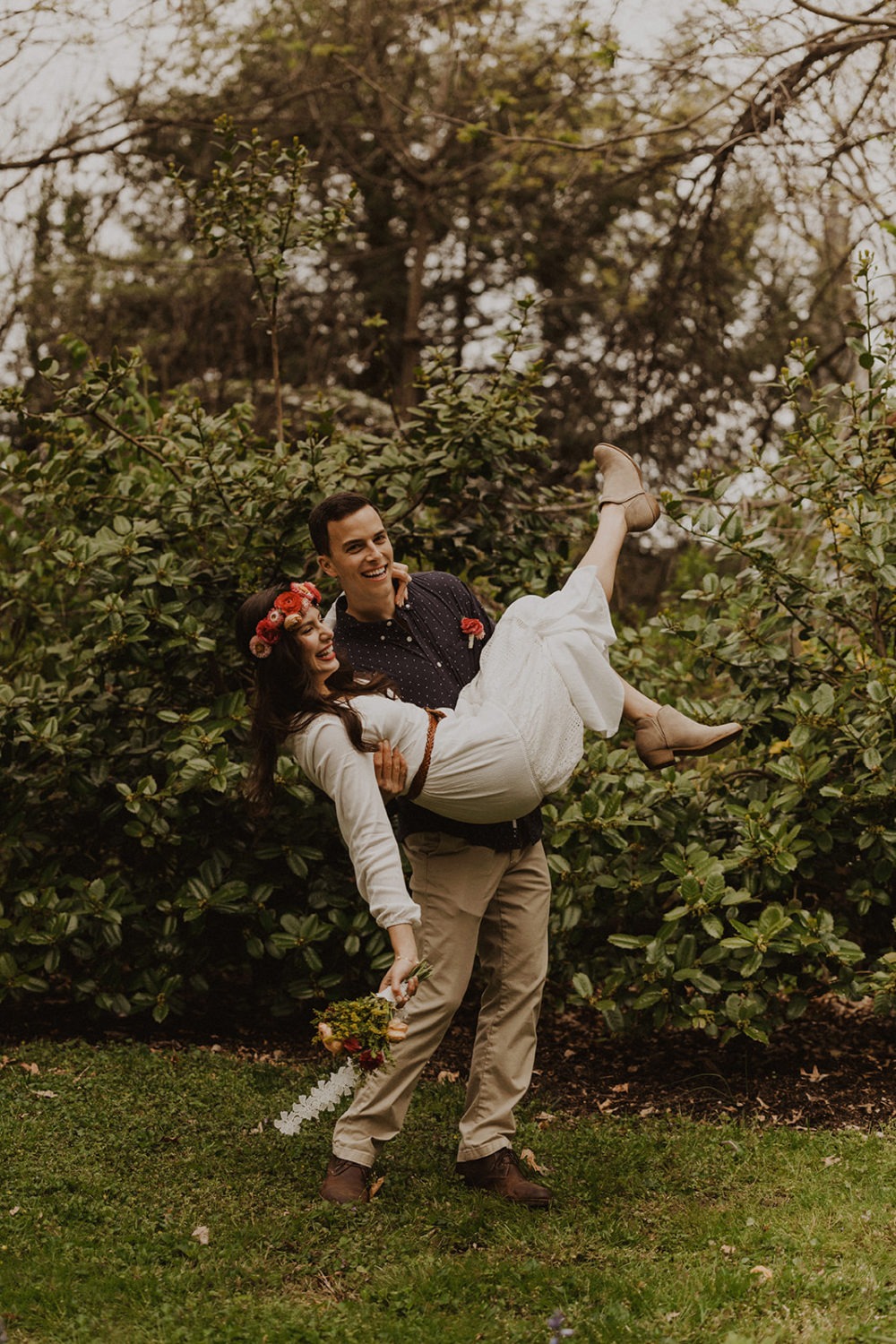 Groom carries bride at spring Virginia park elopement