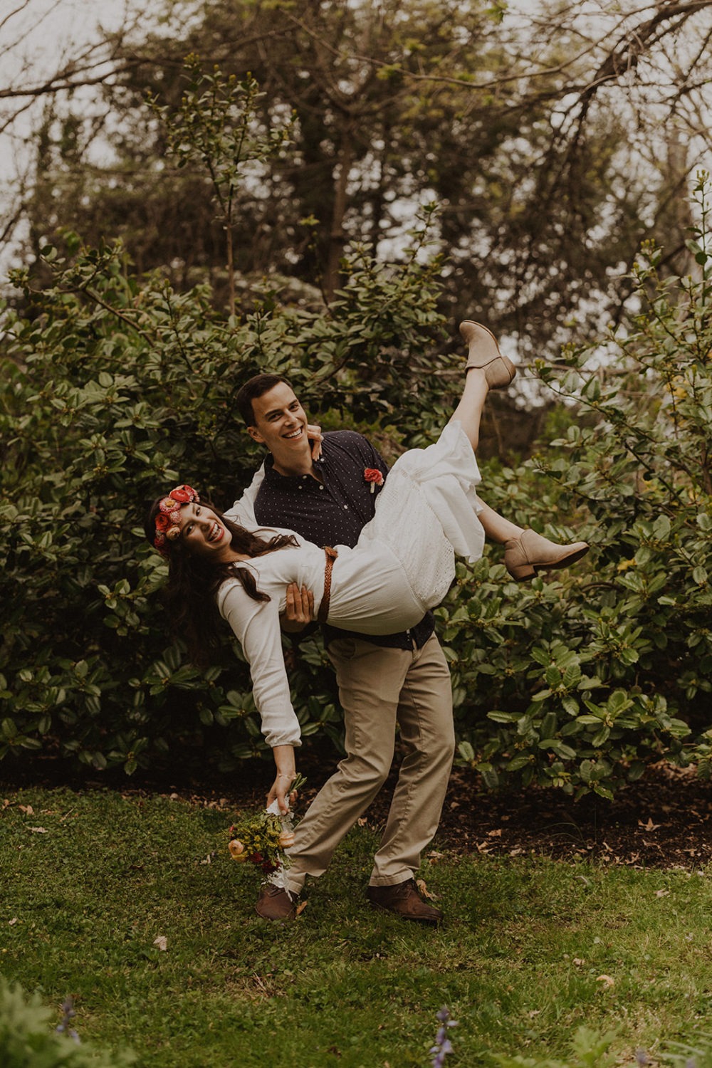 Groom carries bride at spring Virginia park elopement