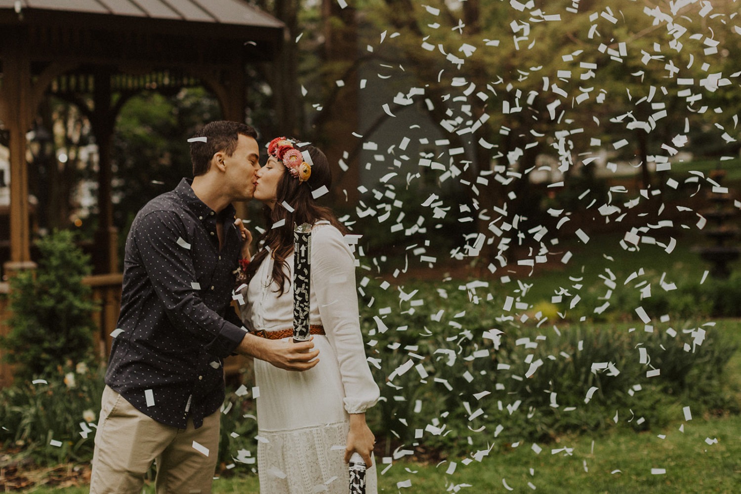 Couple kisses under confetti at spring Virginia park elopement