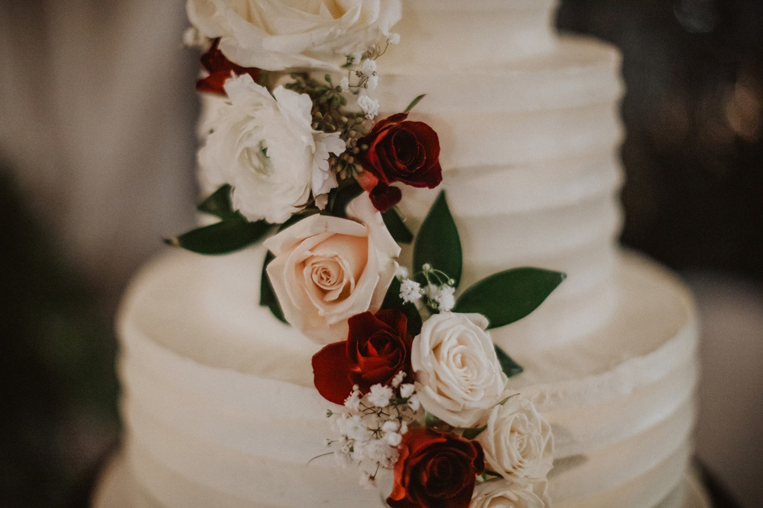 Wedding flowers on white 3-tier wedding cake